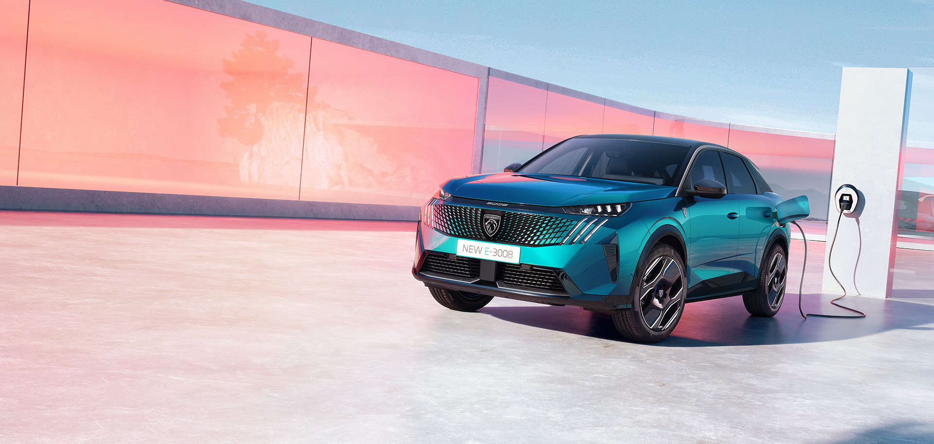 Peugeot e-3008 синього кольору заряджається від електромережі, вигляд спереду з лівого боку